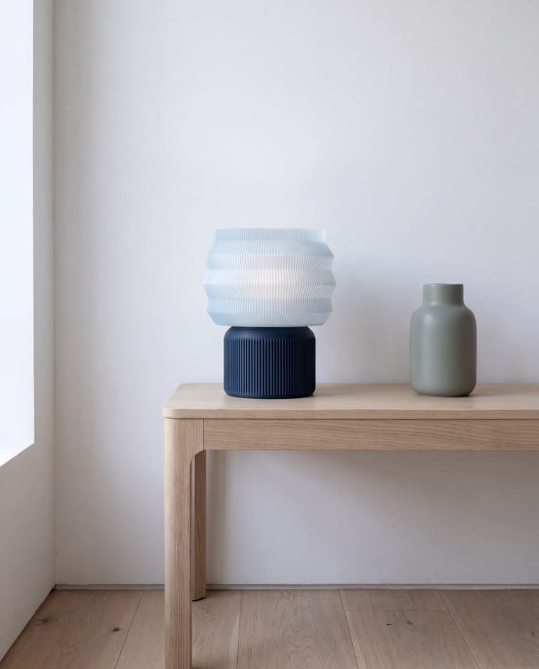 LEAH-lampe i et minimalistisk skandinavisk interiør med hvite vegger, eikegulv og få objekter